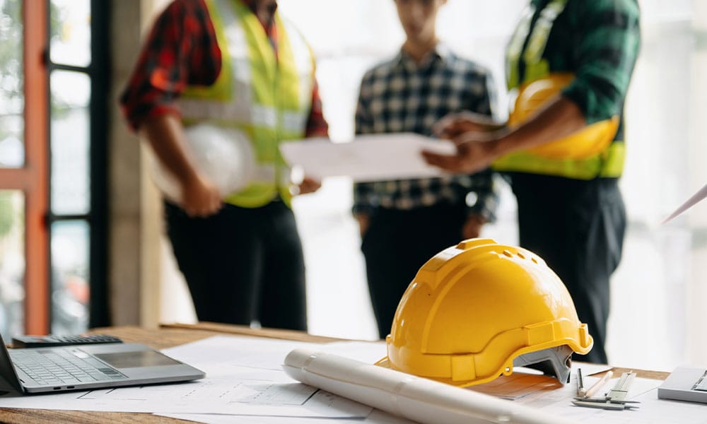 construction workers in San Diego discussing construction defects on their site