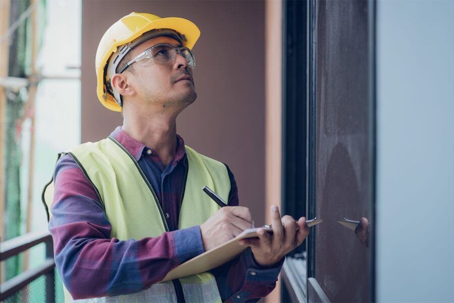 construction worker in San Diego inspecting property damage caused by construction defects