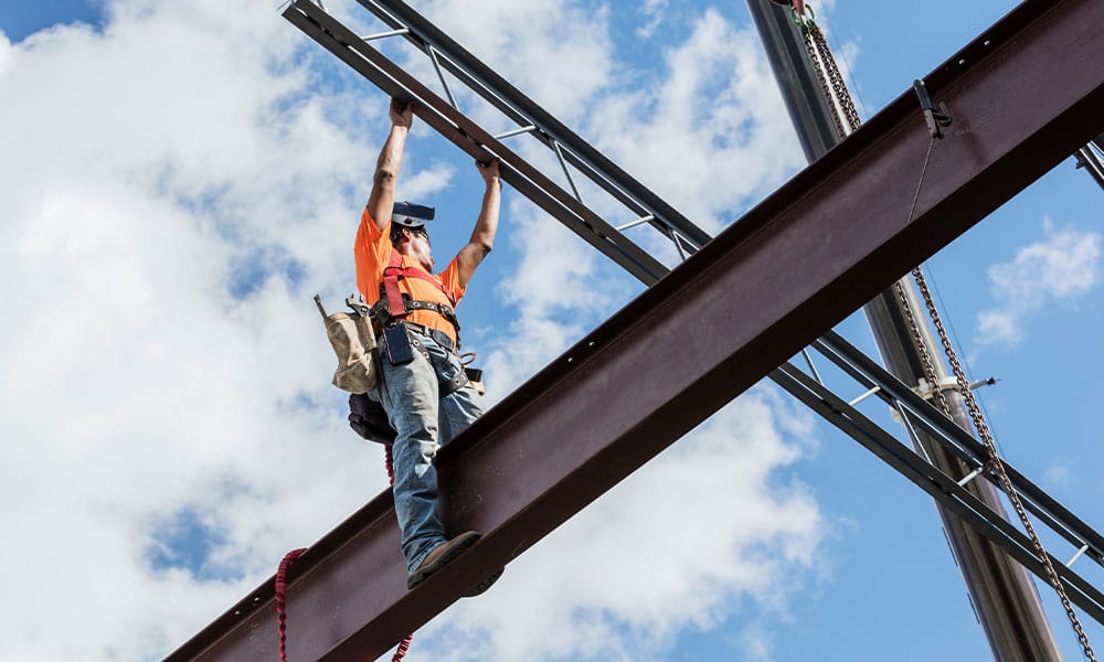 construction worker in San Diego working on a crane, risking an accident