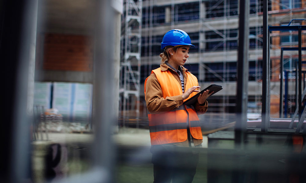 worker on a San Diego construction site inspecting the legal safety regulations and standards