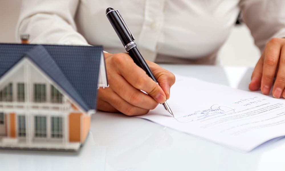 man signing a contract for a construction project in Los Angeles