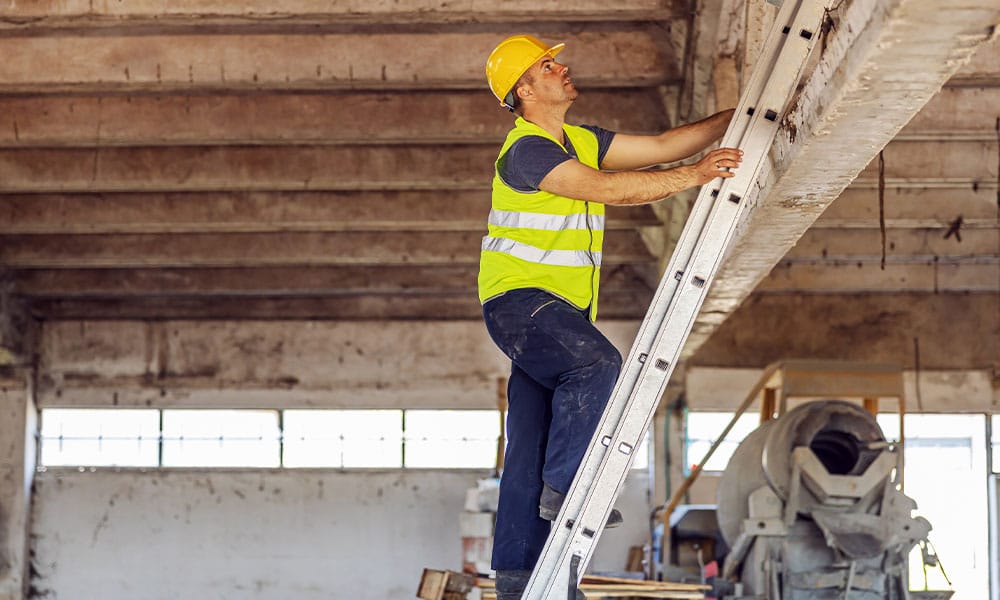 worker climbing a ladder on a Los Angeles construction site before falling