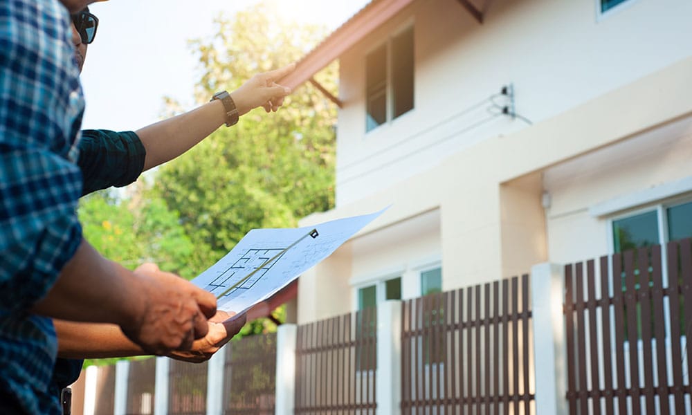 workers discussing a property line dispute in San Diego, CA