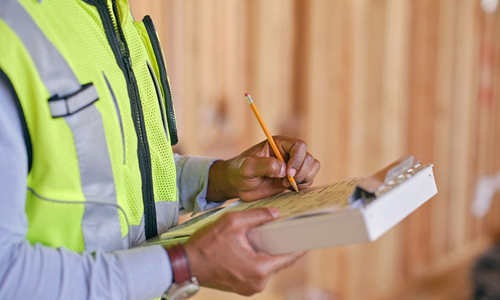 worker inspecting a construction defect in San Diego, CA
